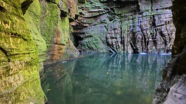 Cinematic forward movement revealing a hidden tropical cave waterfall