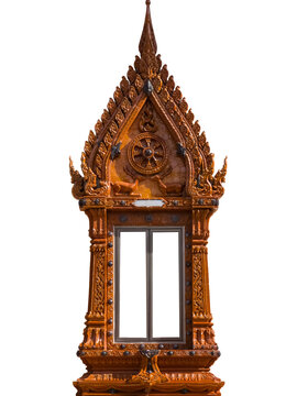 Traditional Thai terracotta temple window frame decorated with intricate relief carvings and Buddhist symbols