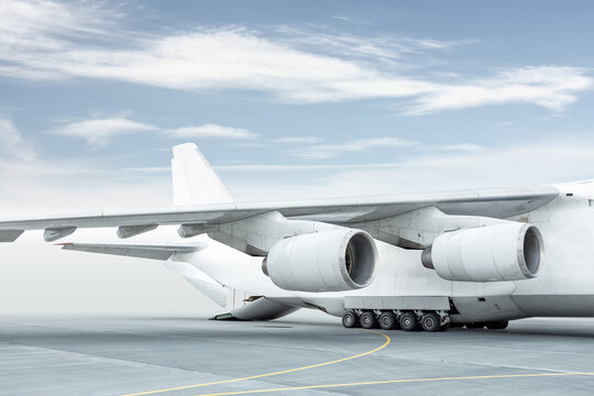 Loading a white big heavy cargo airplane. The rear cargo compartment is open