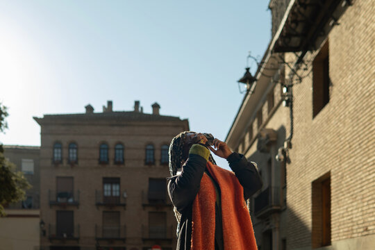 Woman traveling through city photographing historic architecture