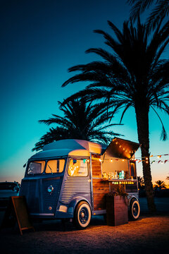 Food truck near palms on beach