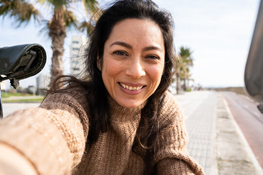 Woman Takes a Self Portrait With a Bicycle on a Sunny Day