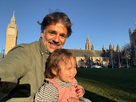 Smiling Parent And Toddler Enjoying Westminster Landscape In London