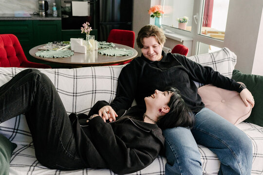 Friends relax and enjoy each other 's company.