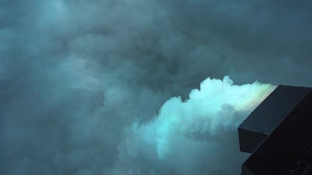 Thick white smoke spreads across the floor. Heavy, cold smoke. Smoke machine. Thick clouds of smoke from a smoke machine create a stunning effect at an event.