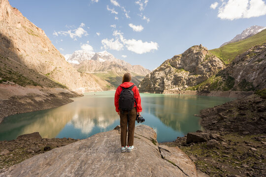 Woman Stands on a Rock at Marguzor Lake in Tajikistan