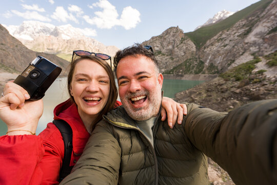 Couple Takes Selfie by Mountain Lake in Haft Kul, Tajikistan
