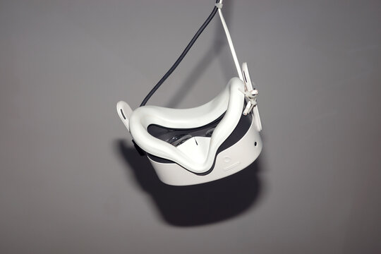Virtual reality headset hanging in a room