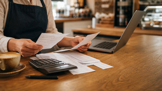 Cafe Owner Reviewing Business Expenses