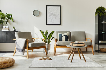 Fototapeta premium Modern retro concept of home interior with design sofa, armchair, coffee table, plants, mock up poster map, carpet and personal accessoreis. Stylish home decor of living room.