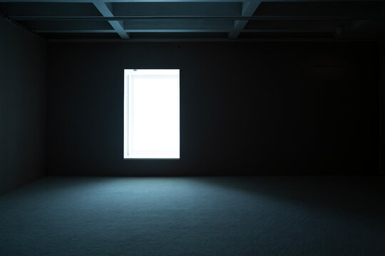 Light Enters a Dark Room Through a Small Window at Night