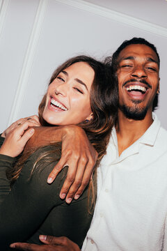 Joyful couple embracing with genuine smiles