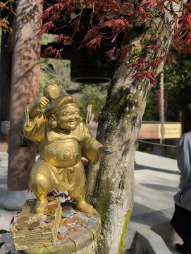 Miyajima Island Golden Daikoku Statue with Coins at Itsukushima Shrine