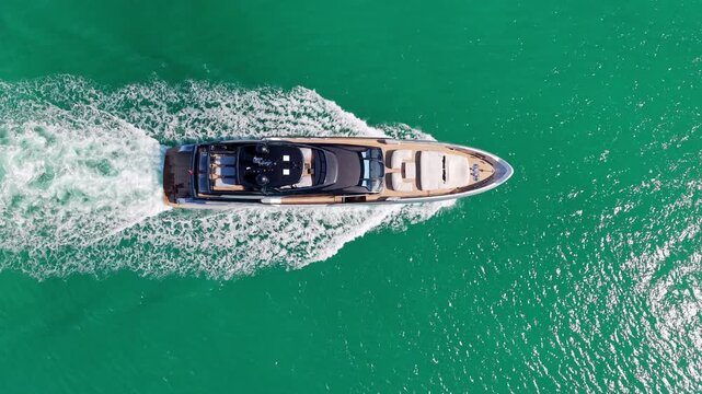 Yacht sails across open sea after quiet marina departure. Luxury motorboat follows boat along coast. Summer vacation continues. Travel feels exciting every moment