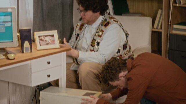 Diverse young adults, including African American woman and Caucasian men, troubleshooting retro desktop computer in nostalgic office. Perfect for vintage technology commercials or IT history videos