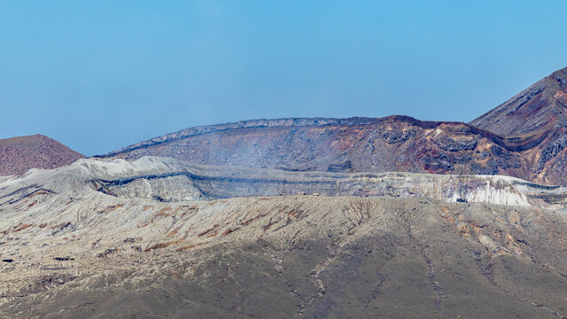 view  to the smoking Nakadake crater of mount Aso in the sunshine