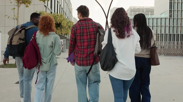 Group of diverse college students walking together on campus