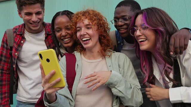 Diverse friends watching funny video on smartphone