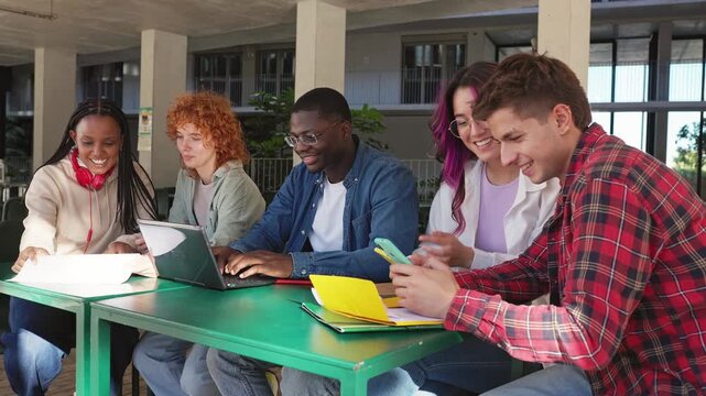 Diverse group of university students studying together