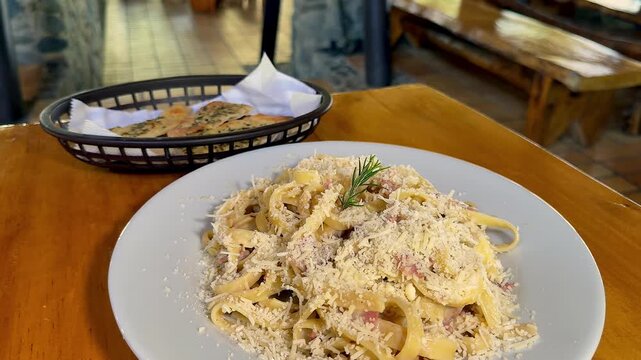 plate of creamy fettuccine carbonara pasta with bacon and parmesan cheese