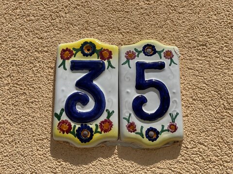 Hand painted ceramic tiles that say number 35