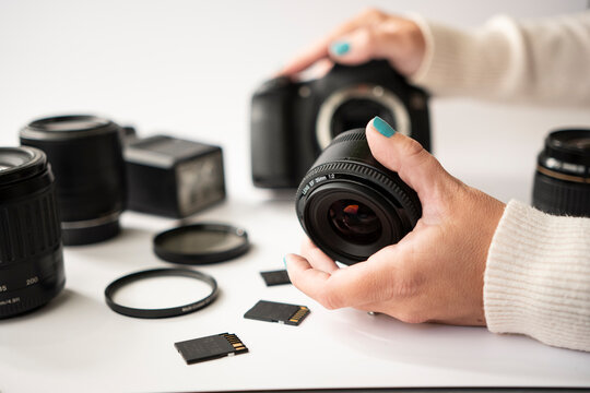 Attaching Camera Lens to DSLR Body on White Surface