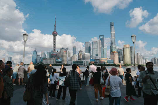 Shanghai, China - SEPTEMBER 22, 2025: Tourists gather on the waterfront with the Shanghai skyline and Oriental Pearl Tower