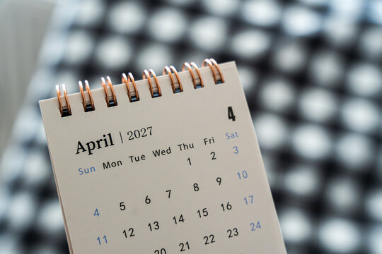 Handwritten calendar page showing April 2027 on a stylish checkered background, symbolizing time management and planning, ideal for business and personal organization use.