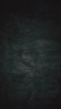 Cinematic abstract animation with gently floating dust particles against a dark grunge texture background. Full HD and looping vertical animation.