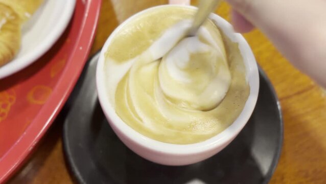 Close-Up of a Cappuccino with Swirled Latte Art in a Pink Cup