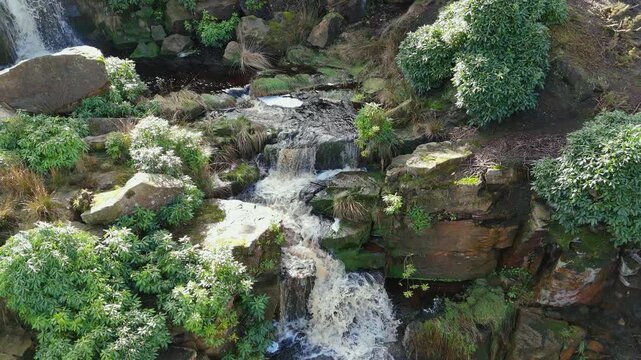 Aerial drone footage of a tall rocky waterfall in the Yorkshire Dales, Pennies. Moorland scene of a majestic waterfalls near Marsden West Yorkshire. Huddersfield Outdoors