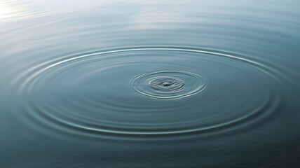 Fototapeta premium Ripples on the surface of calm water, creating concentric circles from a central point of impact, serene blue liquid background with soft lighting