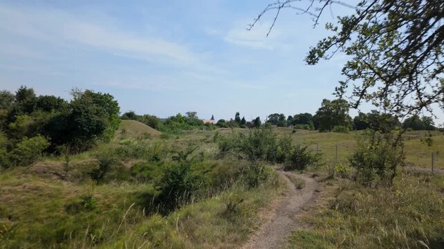 Barnack Hills and Holes, Cambridgeshire, UK - June 2026: walking along top of ridge at the edge of Barnack Hills and Holes NNR on a public footpath on a bright summers afternoon