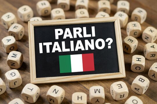 Parli italiano question on chalkboard with italian flag and wooden letter blocks
