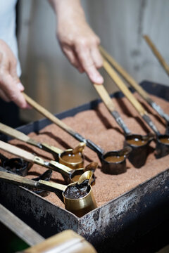 Rustic Turkish coffee ritual cezve brewing over heated sand