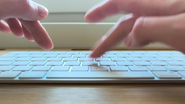 Fingers moving slowly across keyboard keys. Relaxed hand pace during casual computer typing. Close-up scene of unhurried digital work at a desk..