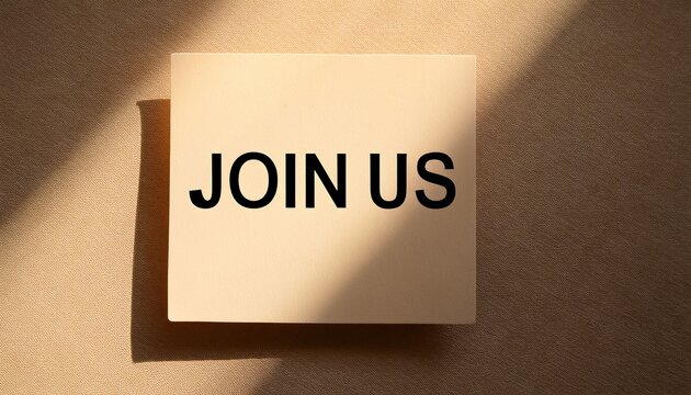 cream paper card displaying join us text on beige with warm sunlight and shadows