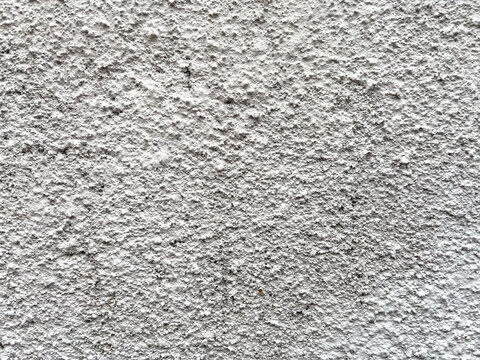 Rough cement plaster finish with a textured surface, showcasing the traditional kamprot technique widely used for durable exterior walls and modern architectural designs.