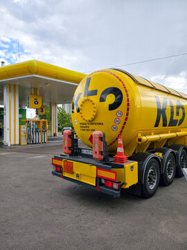 Yellow fuel tanker truck at KLO gas station in Kyiv city, capital of Ukraine, delivering fuel for refueling operations