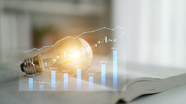 Light bulb symbolizing innovation rests on an open book with digital graphs reflecting financial growth trends, representing a fusion of knowledge and business insights. Scalp