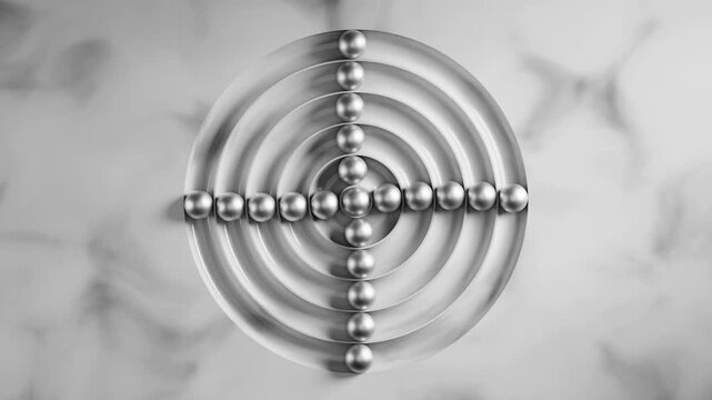 Metallic balls oscillate between a circular and cross shaped arrangement