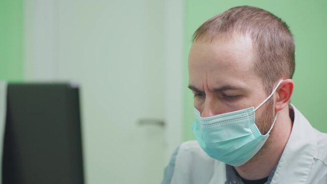 portrait man doctor works with computer