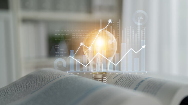 A light bulb illuminated on an open book, featuring financial graphs and data visualizations, represents creativity and innovation in business ideas and strategies. Scalp