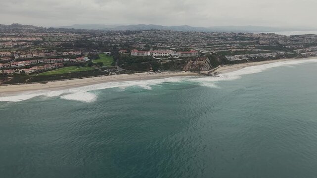drone parallax of city on coastline