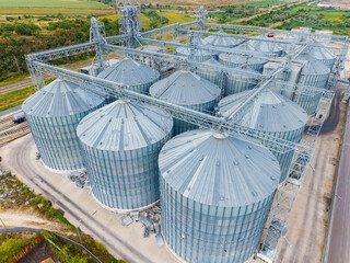 Storage silos at a large agricultural facility in a rural area under a clear sky © DSMT