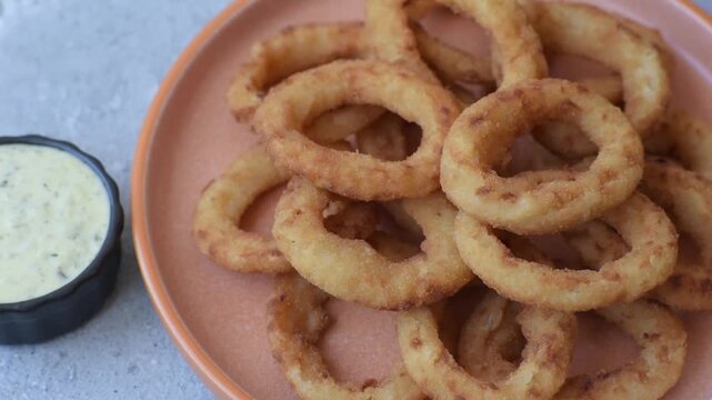 Deep fried breaded onion or squid rings, crispy fast food snacks. Fried onion or squid rings as a food background for your design