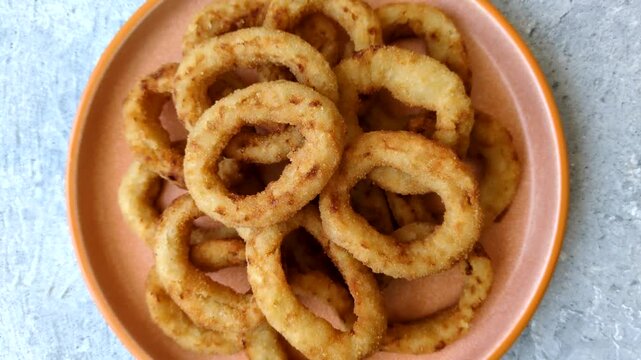 Deep fried breaded onion or squid rings, crispy fast food snacks. Fried onion or squid rings as a food background for your design