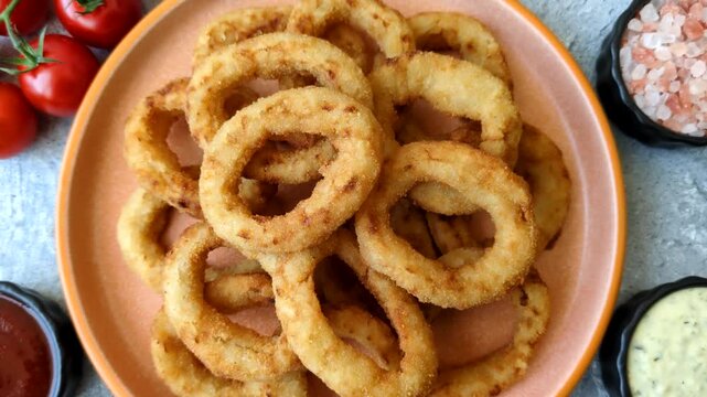 Deep fried breaded onion or squid rings, crispy fast food snacks. Fried onion or squid rings as a food background for your design