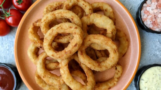 Deep fried breaded onion or squid rings, crispy fast food snacks. Fried onion or squid rings as a food background for your design
