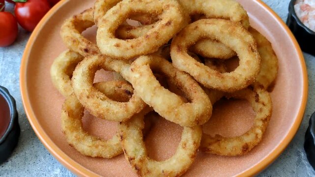 Deep fried breaded onion or squid rings, crispy fast food snacks. Fried onion or squid rings as a food background for your design